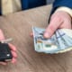 Businessman holding car key and money