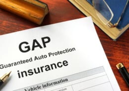 GAP insurance form on a table with a book.